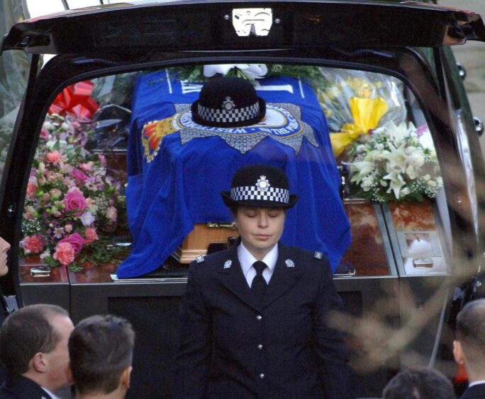 Pc Teresa Milburn, who was also shot during the incident, stands in front of Sharon Beshenivsky’s coffin following the funeral service at Bradford Cathedral.