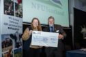 RHET executive officer Katrina Barclay presented with cheque by NFUS president Martin Kennedy.