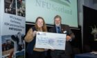 RHET executive officer Katrina Barclay presented with cheque by NFUS president Martin Kennedy.
