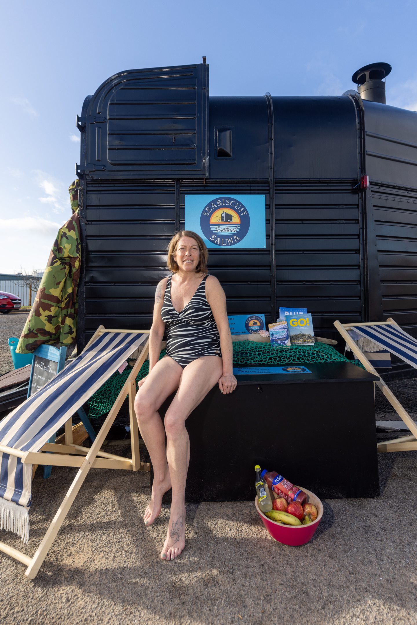 Debbie Thornton by her mobile sauna on Aberdeen Beach.