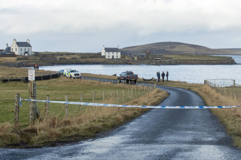Police cordon in Sandness, Shetland, with parts of car on roadside