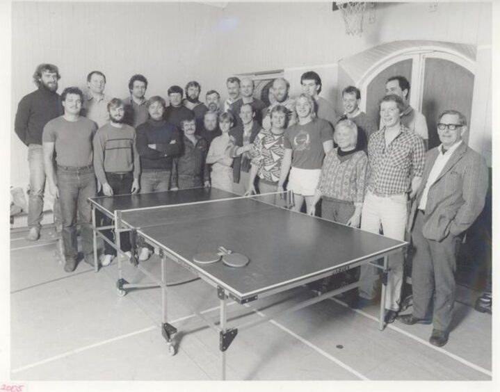 Locals and Klondykers around a table tennis table