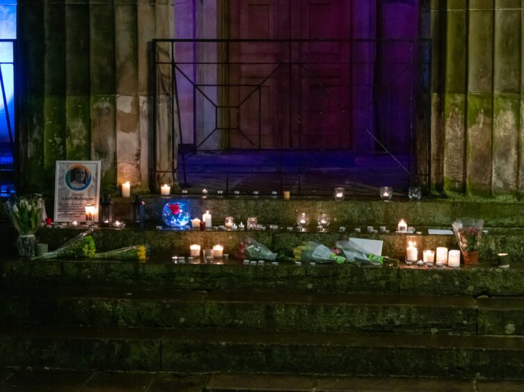 Candles covered the steps of St Giles Church in Elgin to mourn Keith Rollinson.