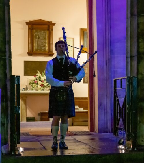 Piper Jack Phillipson stepped forward to perform a Piper's Lament at the candlelight vigil for Keith Rollinson.