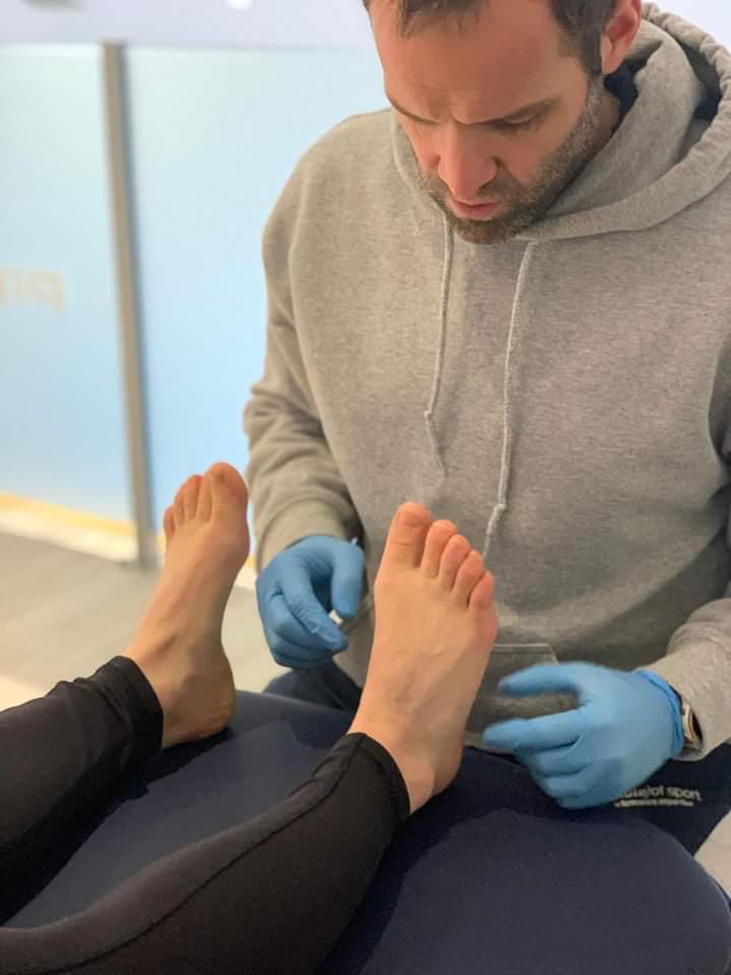 James Cruickshank inspects the feet of a client
