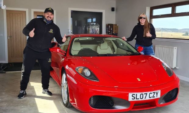 Calvin and Leanne with a Ferrari which was the second supercar to be given away. Image: Bounty Competitions.