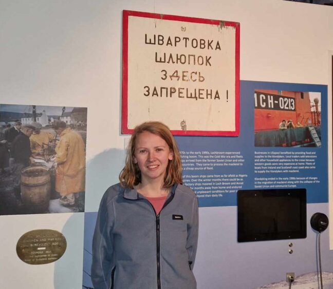 Mairead Bush, marketing and events assistant at Ullapool Museum with a display about the Klondykers behind her