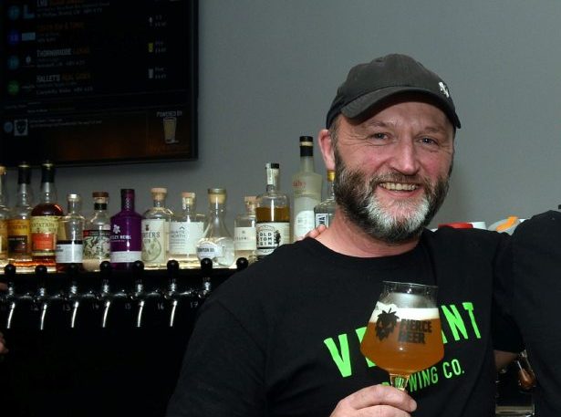 Fierce Beer co-founder Dave Grant holding a drink at his bar in Aberdeen.