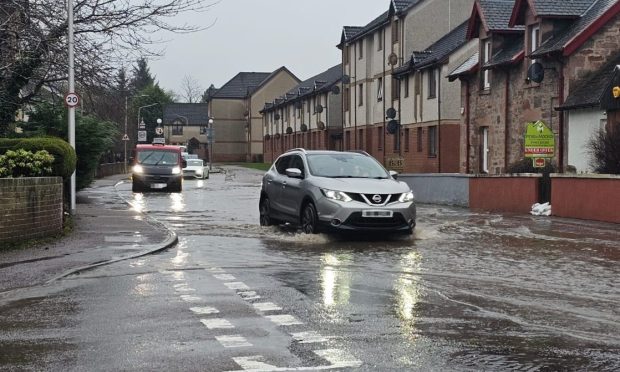 Cars driving through flooding on Diriebught road.