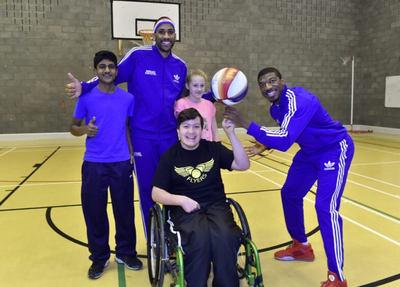 Harlem Globetrotters - Buckets Blade and Zeus McClurkin - showing their skills and raising awareness of their ABCs of Bullying Prevention campaign. Jay Moir 15, (front) with back, (from left) Lyndon Dias 13, Zeus McClurkin, Ugne Paskoaite, 12 and Buckets Blakes.