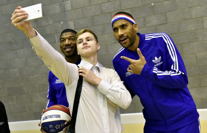 St Machar Academy hosted two of the Harlem Globetrotters - Buckets Blade and Zeus McClurkin - showing their skills and raising awareness of their ABCs of Bullying Prevention campaign. They are pictured getting a selfie with sixteen-year-old Erik Rosljajev.