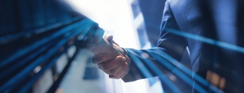 Businessmen making handshake with partner.