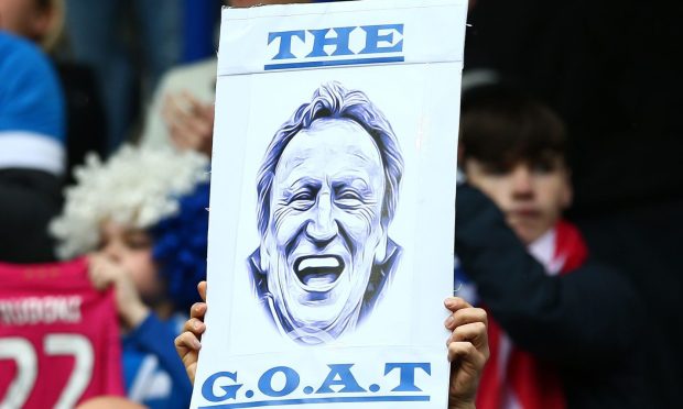 A sign held up by a fan during Neil Warnock's last managerial job with Huddersfield Town. Image: Shutterstock.
