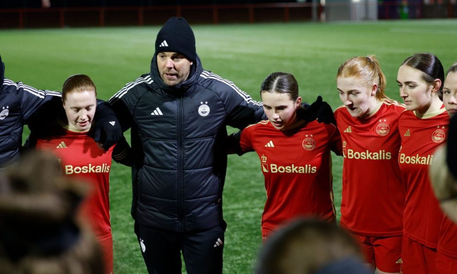 Aberdeen Women manager Clint Lancaster delivers a post-match talk to his players.