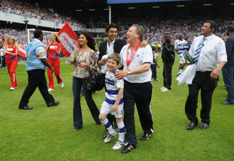 Queens Park Rangers manager Neil Warnock shares a laugh with chairman Ishan Saksena after winning the English Championship in 2011. Image: Shutterstock.