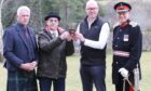 Charlie Murray, chairman of the Royal Scottish Highland Games Association, grandson Adrian Taylor, Jonathan Christie, chief executive of the Cabrach Trust and  the Lord Lieutenant of Banffshire with the trophy.