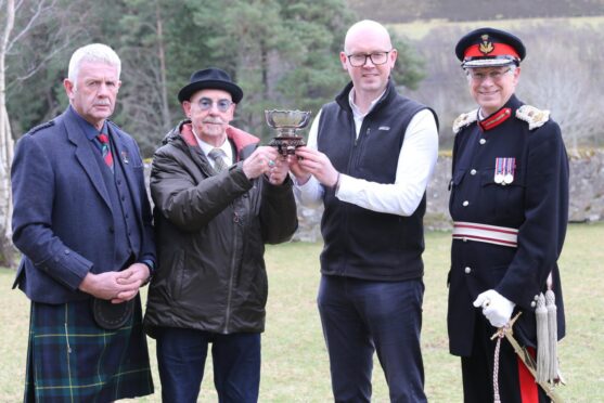 Charlie Murray, chairman of the Royal Scottish Highland Games Association, grandson Adrian Taylor, Jonathan Christie, chief executive of the Cabrach Trust and  the Lord Lieutenant of Banffshire with the trophy.