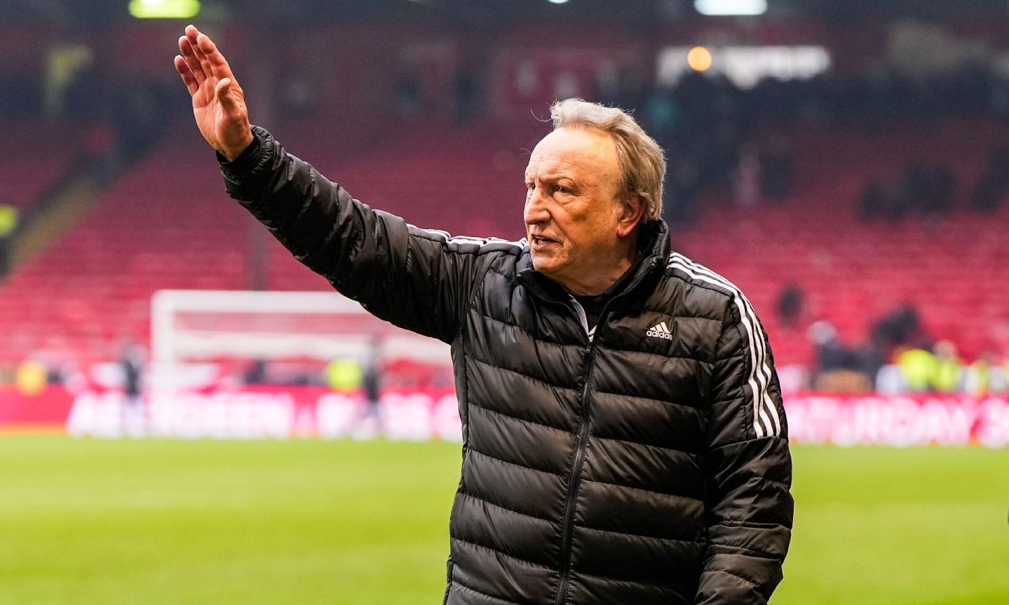 Aberdeen manager Neil Warnock waves to the fans as he walks off the pitch at full-time after beating Kilmarnock. Image: Shutterstock.