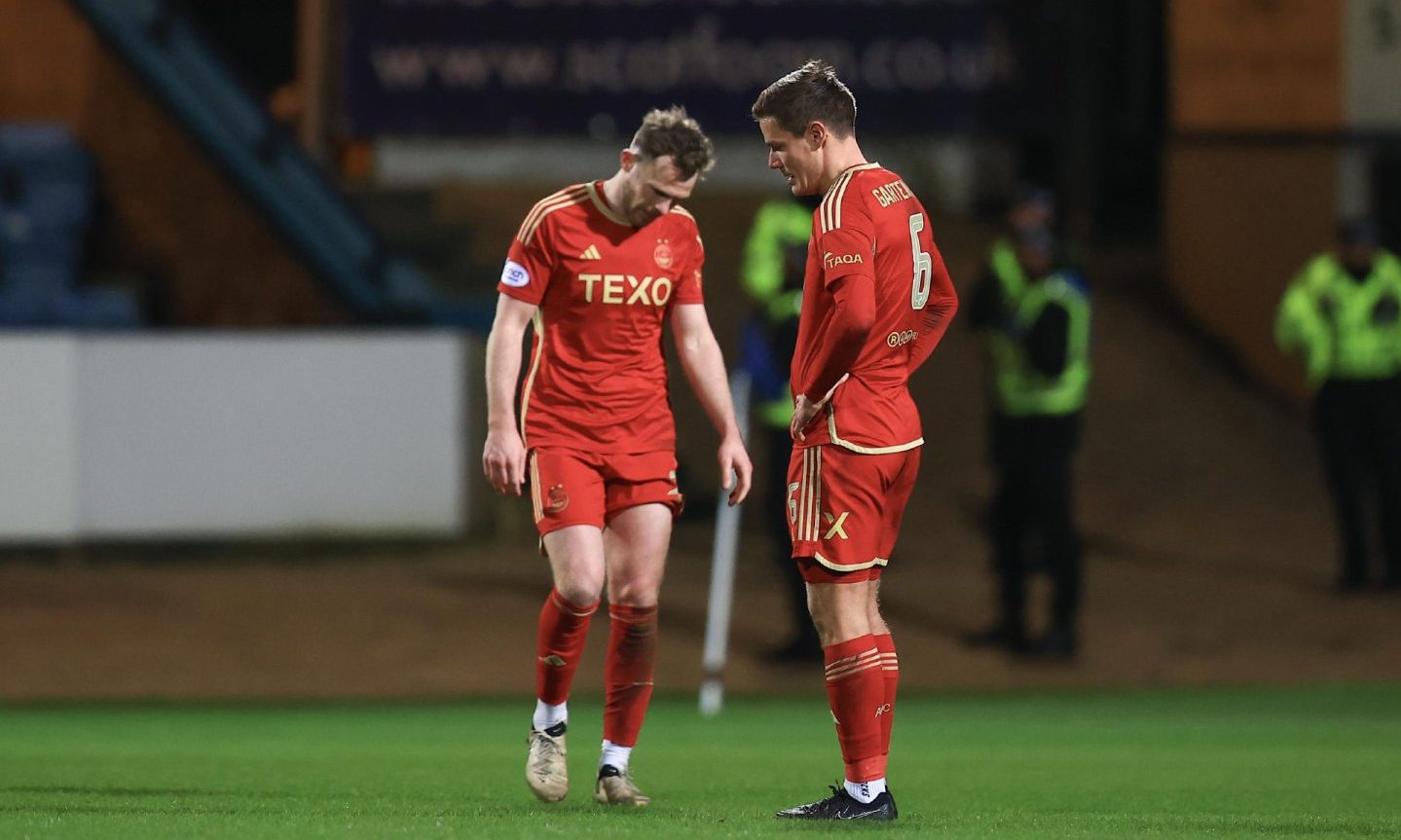 Stefan Gartenmann and Nicky Devlin of Aberdeen look dejected at the end of the 1-0 loss to Dundee. Image: Shutterstock