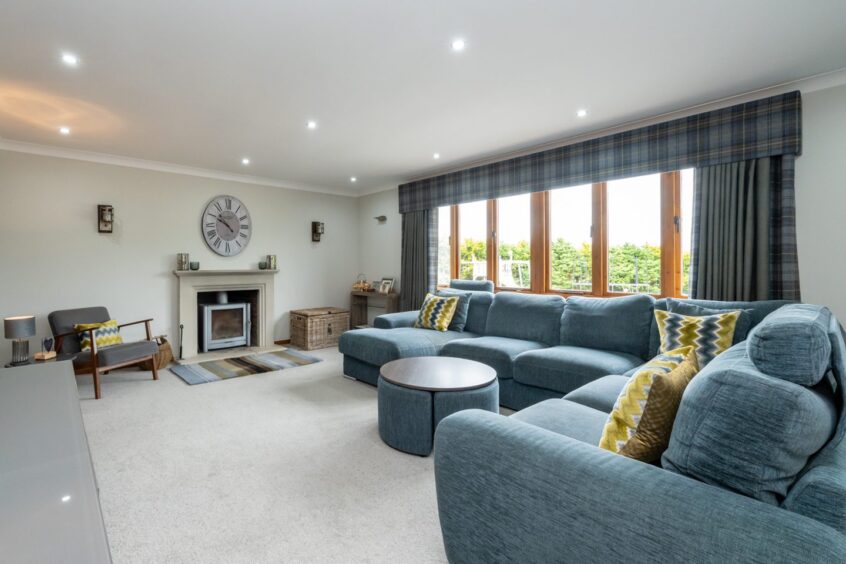 Large lounge area with shades of blue and cream inside Aldwyn Park House in Auchnagatt.