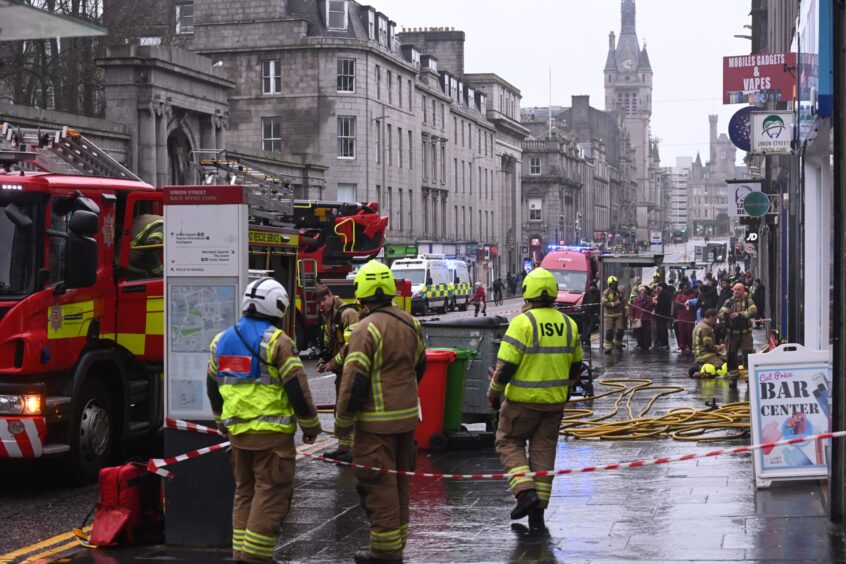 Firefighters pictured at the scene of a fire on Union Street in Aberdeen. 