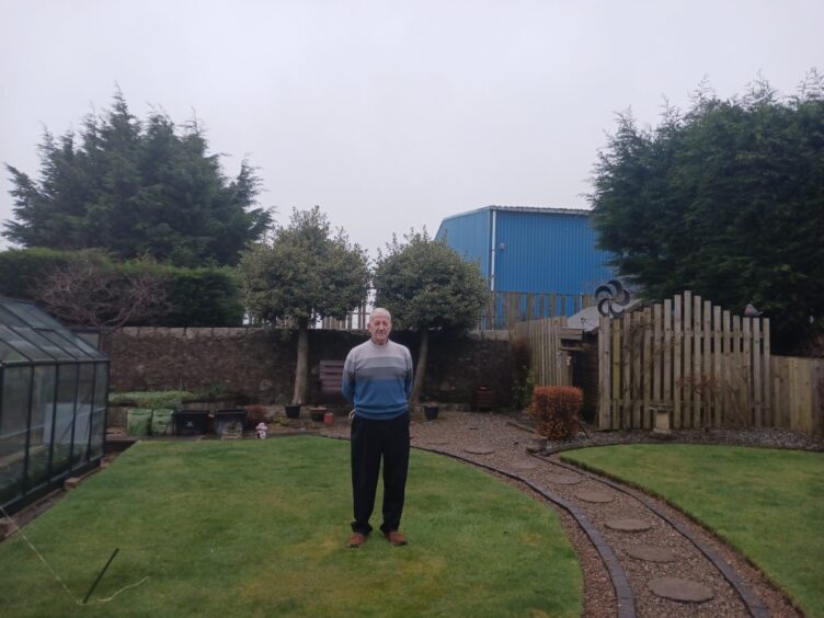 Doug Hynds standing in garden.