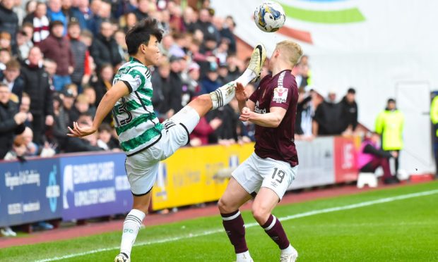 Celtic's Yang Hyun-jun fouls Hearts' Alex Cochrane with a high foot which leads to a red card following a VAR check. Image: SNS.
