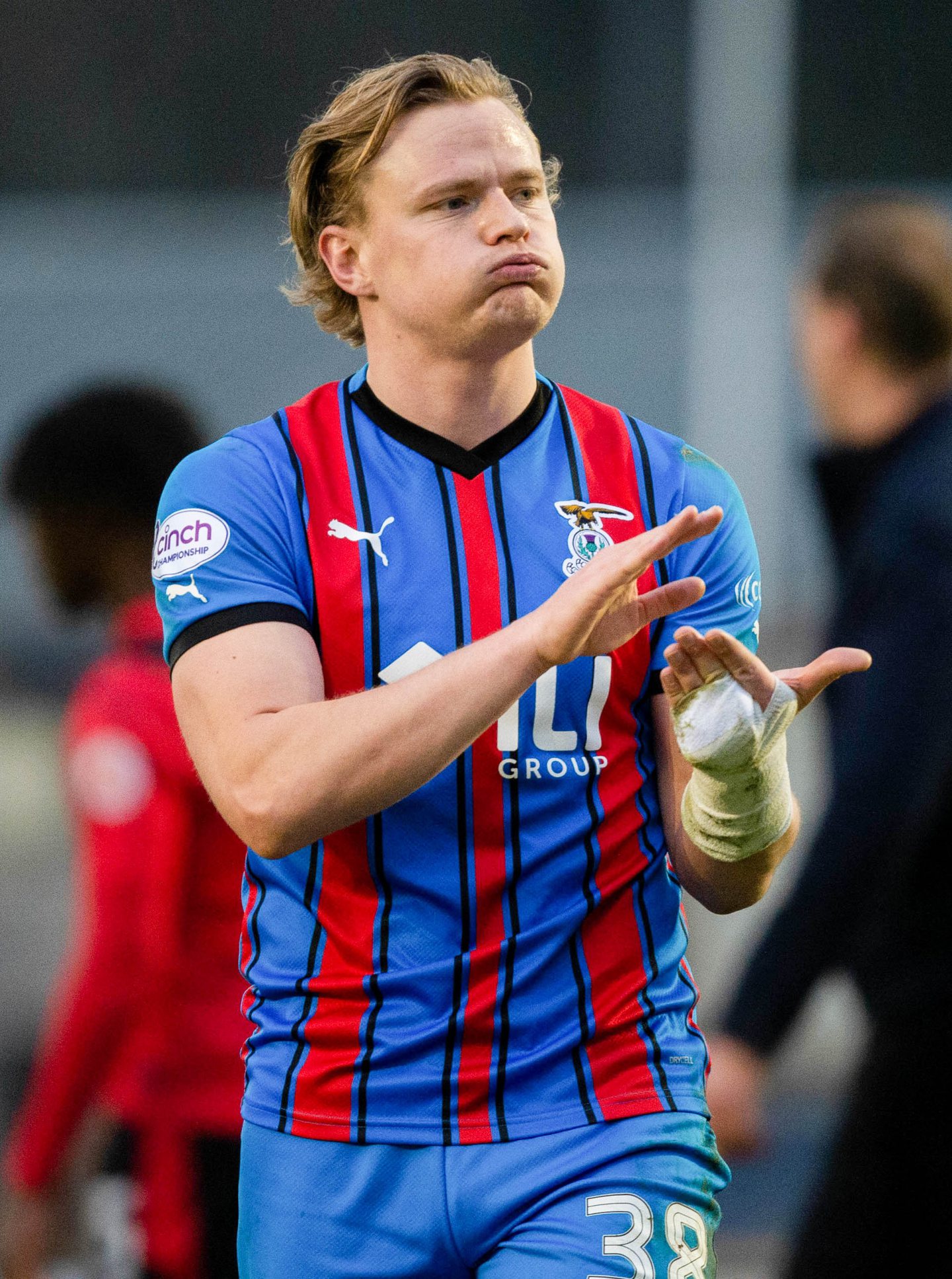 Alex Samuel applauds the Inverness fans at full-time. 