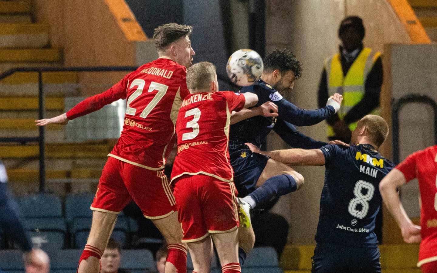 Aberdeen's Jack McKenzie (C) handles the ball in the box to concede a penalty against Dundee. Image: SNS.