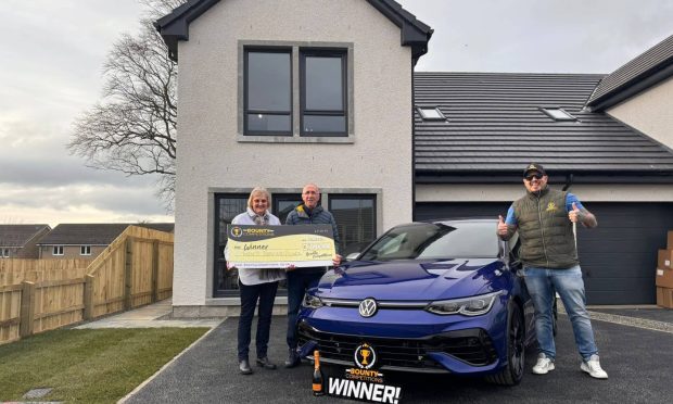 Eunice Mckay pictured outside new house next to new car