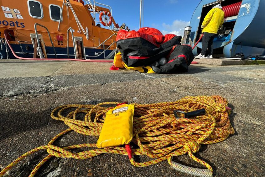 Image shows the 'hi-line' rope used for helicopter lifting operations, recovered with other floating debris. 