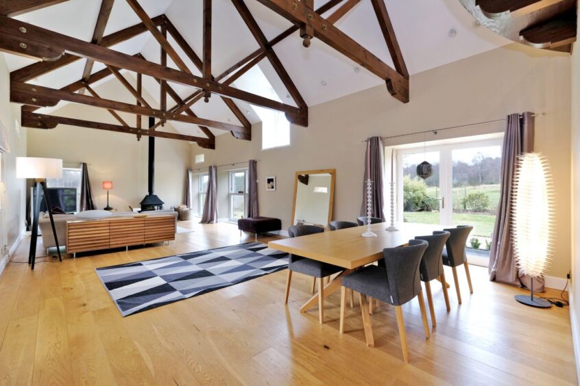 Open plan lounge and dining area in the steading conversion in Aberdeenshire, with French doors out to the garden.