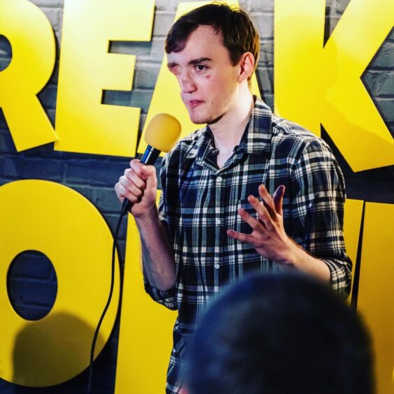 Comedian Aiden Cowie on stage at the Breakneck club in Aberdeen