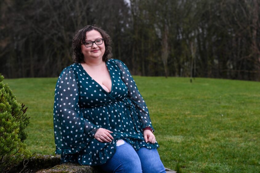 Kirsty sits on a wall near her home in Ellon.