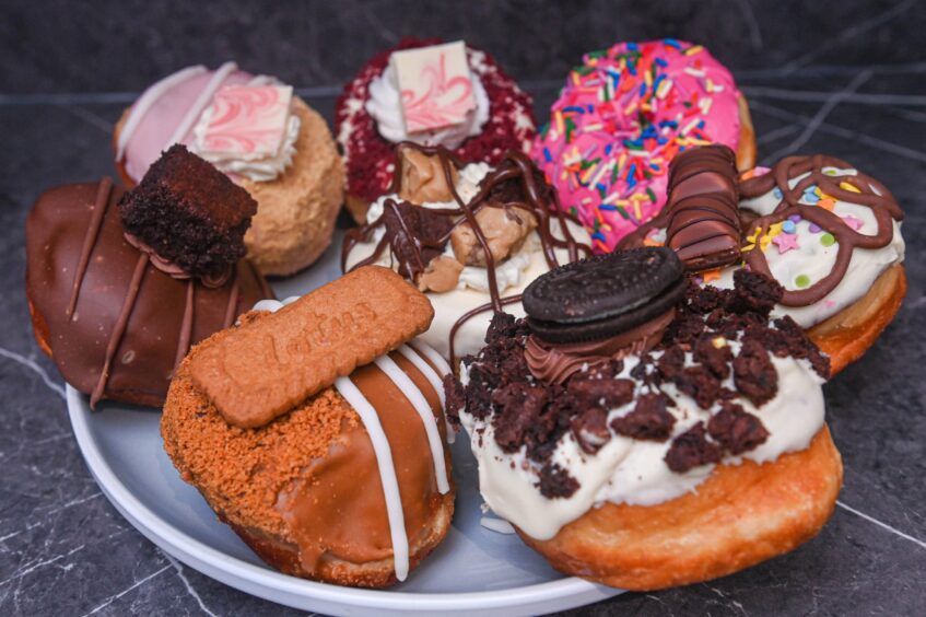 The eight flavours in the Totally Dough range including the iconic Homer Simpson pink doughnut with colourful sprinkles.