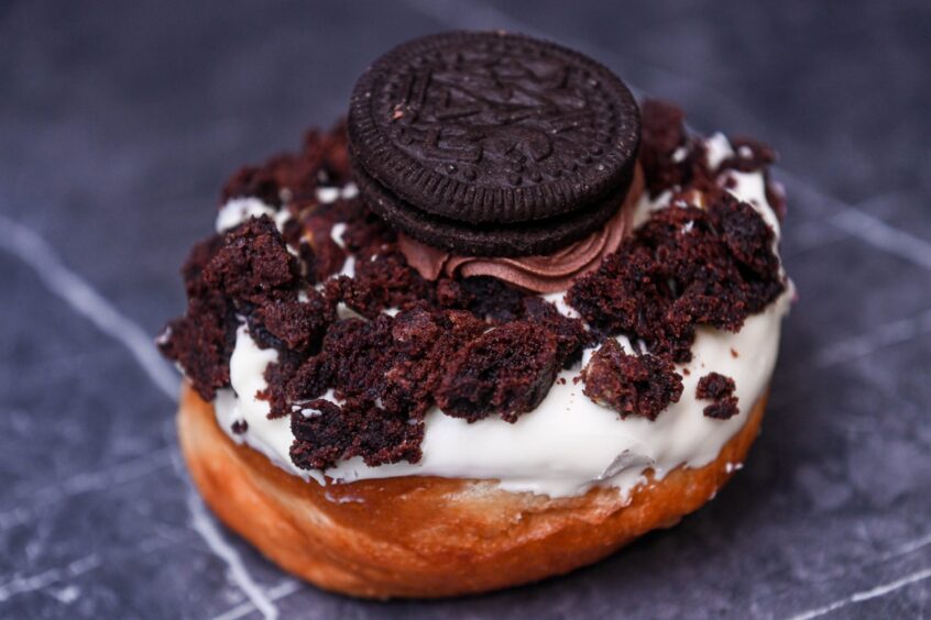 A Super M'oreo doughnut that's topped with a full Oreo cookie.