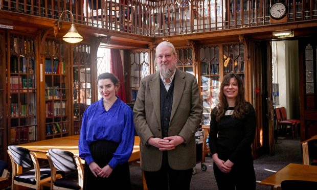 Professor John Behr and students Alyth Forbes, left, and Cyrielle Vallet-Simond inside Aberdeen's Divinity Library.
Image: Darrell Benns/DC Thomson.