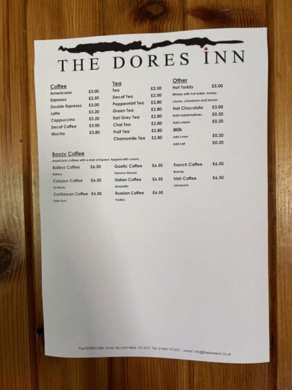A wall-mounted drinks menu at The Dores Inn.