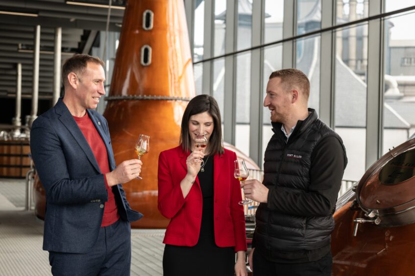 Diageo's Ewan Andrew, Aimee Morrison and Ali McDonald celebrate the reopening of Port Ellen Distillery.