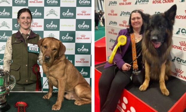 Dog handlers posing with pets at Crufts
