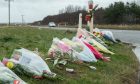 Floral tributes left at the scene of the accident have been moved to a safer spot. Image: jasperimage