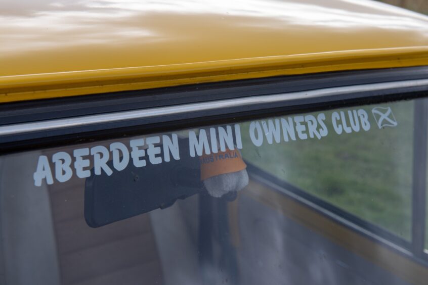 Yellow Mini bearing the Aberdeen Mini Owners Club branding.