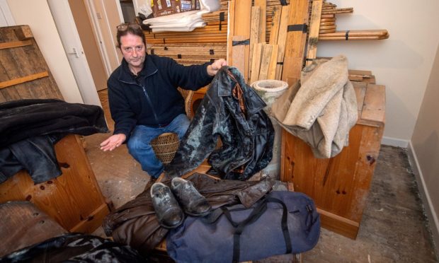 Gordon Rhind's jackets and a pair of shoes are covered in mould. Image: Kath Flannery/DC Thomson