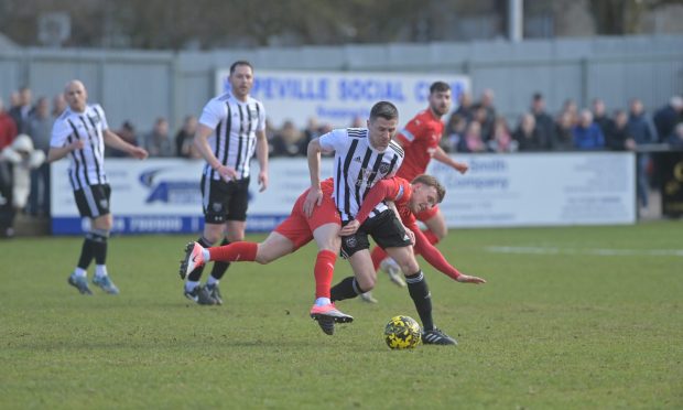 Fraserburgh's Paul Young battles with Brora's Tony Dingwall. Pictures by Kath Flannery/DCT Media.