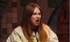 Karen Gillan pictured with ginger hair and wearing a cream jacket screws her face up after discovering what Haggis is made from.