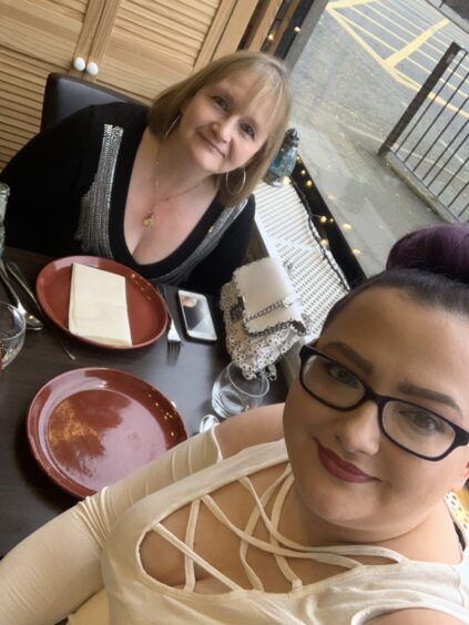 Kirsty and her mum Jan eating dinner at a restaurant in 2019