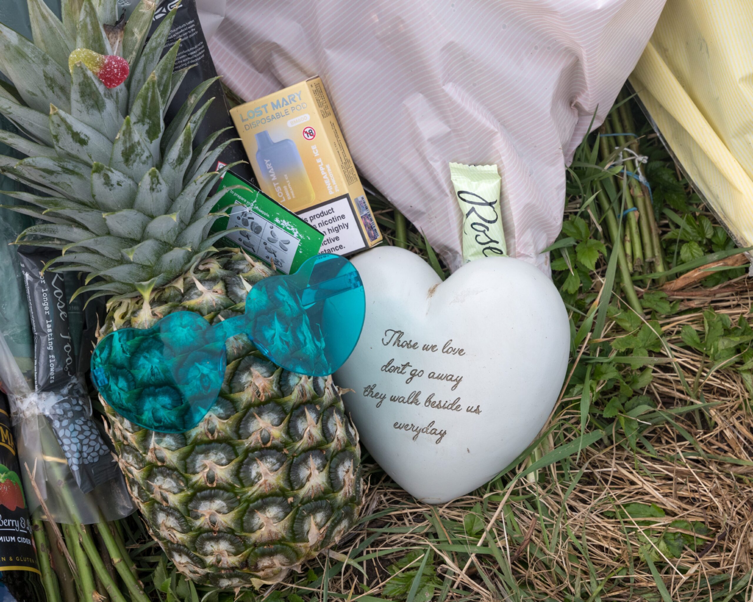 Pineapple with green sunglasses on next to love heart tribute. 