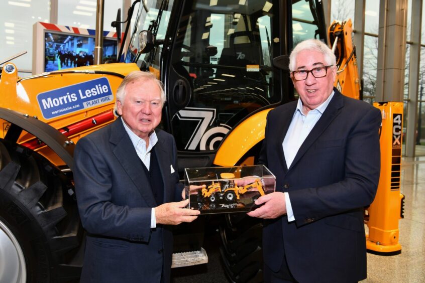 Anthony Bamford, presents Morris Leslie with a special scale model version of the Platinum Edition backhoe loader produced to mark the JCB machine’s 70th birthday.