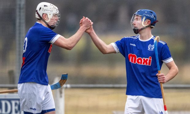 Kyles' Ross MacRae (right) celebrates his penalty goal against Newtonmore with Scott Macdonald.  Image: Neil Paterson.