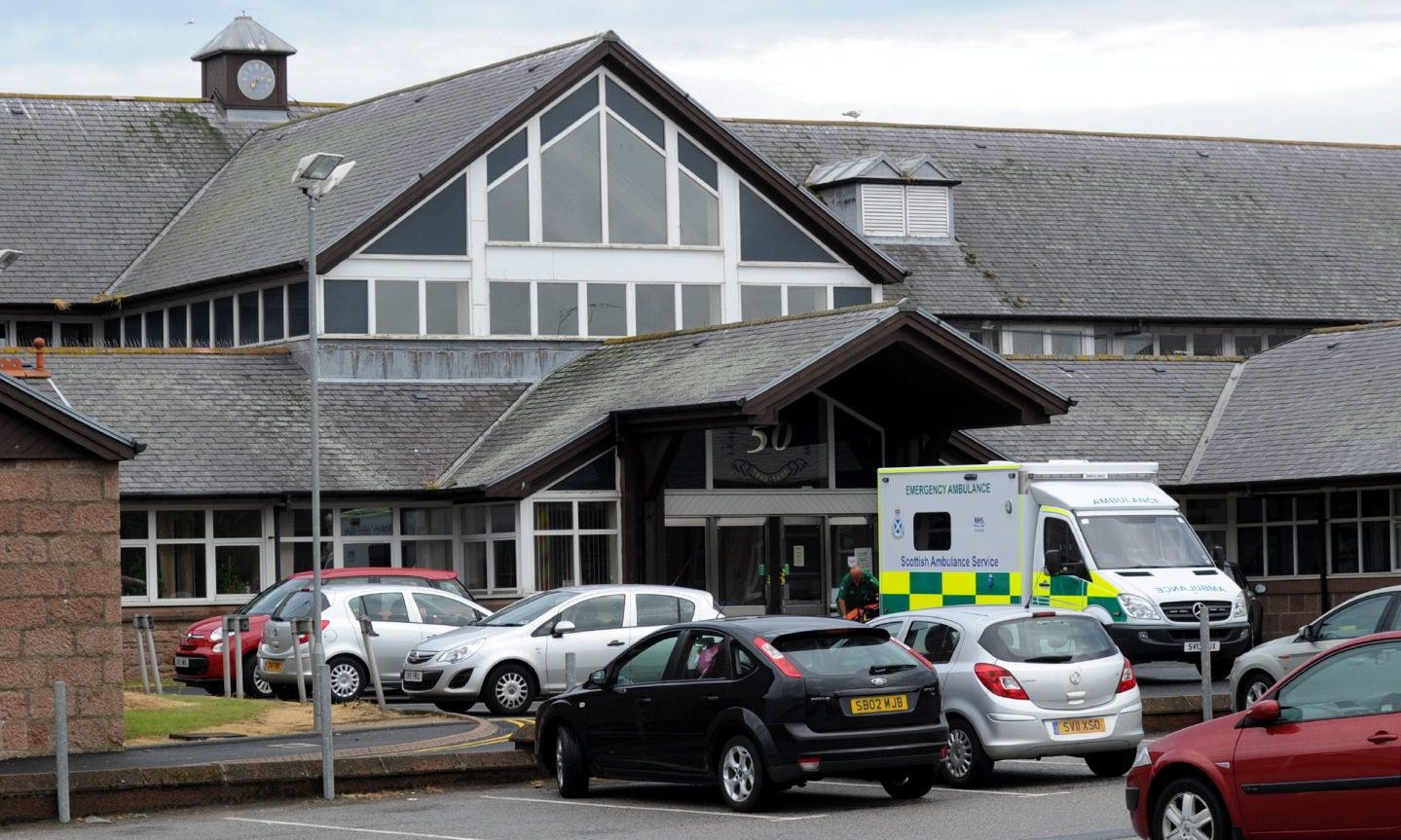 Ambulance and parked cars outside the main entrance of Peterhead community hospital.